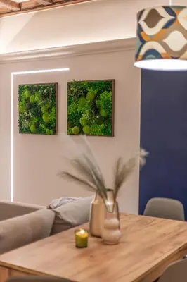 a table with a vase on it with two paintings at Key Apartment Trastevere in Rome