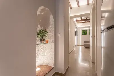 a hallway with a wall with an arch in it at Key Apartment Trastevere in Rome