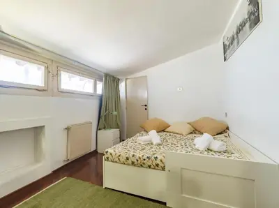 a bedroom with a bed with two pillows on it at Flaminia Luxury Hideaway in Rome