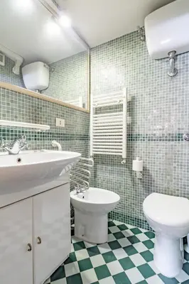 a bathroom with a sink and a toilet at Flaminia Luxury Hideaway in Rome