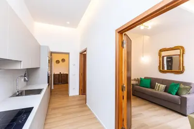 a kitchen and a living room with a couch at Cola di Rienzo Apartment by Rental in Rome in Rome