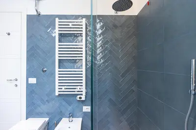 a bathroom with a shower with a ladder on the wall at Cola di Rienzo Apartment by Rental in Rome in Rome