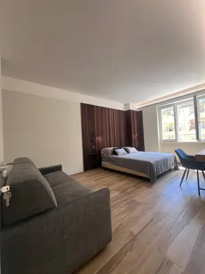 a living room with a bed and a couch at Luxury AV Vaticano in Rome