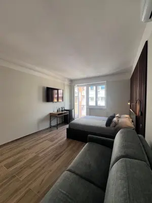 a bedroom with two beds and a couch at Luxury AV Vaticano in Rome