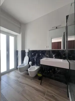 a bathroom with a sink and a toilet and a tub at Luxury AV Vaticano in Rome