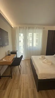 a bedroom with a desk and a bed and a table at Luxury AV Vaticano in Rome