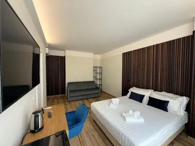 a bedroom with a bed and a table and a chair at Luxury AV Vaticano in Rome