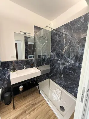 a bathroom with a sink and a shower at Luxury AV Vaticano in Rome