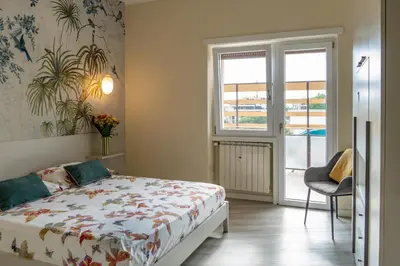 a bedroom with a bed and a window at 18 Vatican Penthouse in Rome