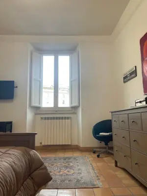 a bedroom with a bed and a dresser and a window at Casa Vannozza De' Cattanei in Rome