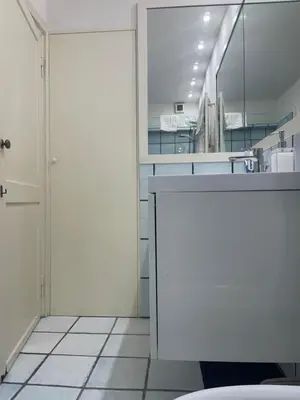 a white bathroom with a sink and a mirror at Casa Vannozza De' Cattanei in Rome