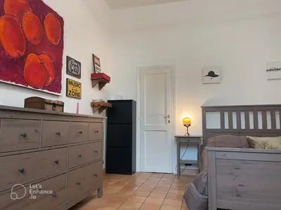 a bedroom with a bed and a dresser and a painting at Casa Vannozza De' Cattanei in Rome