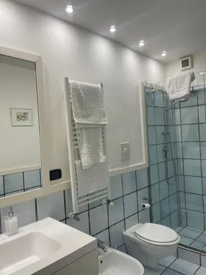 a bathroom with a shower and a toilet and a sink at Casa Vannozza De' Cattanei in Rome