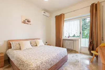 a bedroom with a bed and a large window at MaSa Holidays House Vatican in Rome
