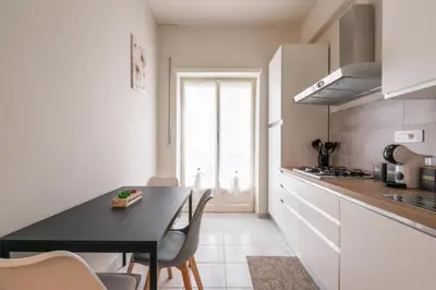 a kitchen with a table and chairs in a room at MaSa Holidays House Vatican in Rome