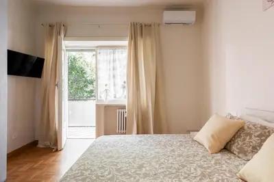 a bedroom with a bed and a large window at MaSa Holidays House Vatican in Rome