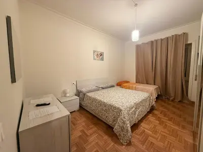 a small bedroom with two beds and a dresser at MaSa Holidays House Vatican in Rome