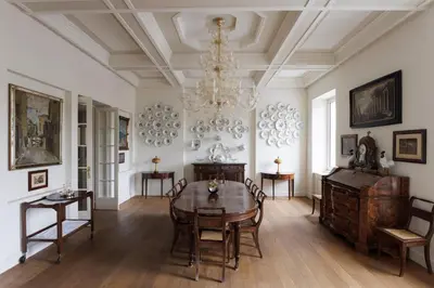 a dining room with a table and chairs and a chandelier at Sant'Angelo Apartment in Rome
