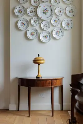 a table with plates on a wall at Sant'Angelo Apartment in Rome