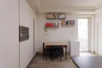 a kitchen with a table and chairs and a window at Sant'Angelo Apartment in Rome