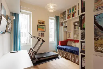 a room with a treadmill and a couch in it at Sant'Angelo Apartment in Rome