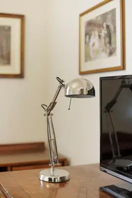 a lamp sitting on a desk next to a computer monitor at Sant'Angelo Apartment in Rome