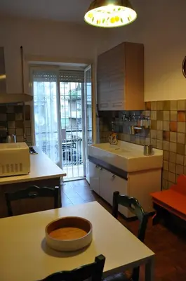 a kitchen with a table and a counter top at Big Home In Vatican in Rome