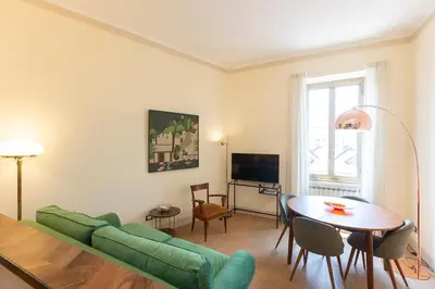 a living room with a green couch and a table at Casa Prati by Rental in Rome in Rome