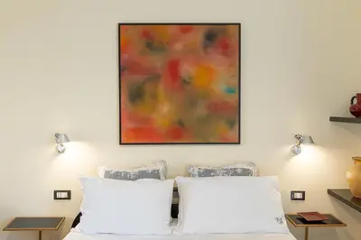 a bedroom with two white pillows and a painting on the wall at Casa Prati by Rental in Rome in Rome
