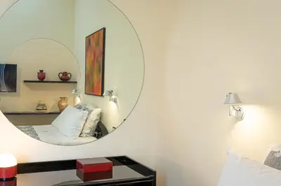 a mirror in a room with a bed and a table at Casa Prati by Rental in Rome in Rome