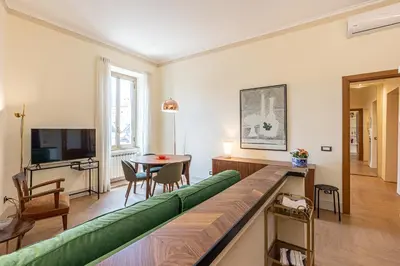 a living room with a green couch and a table at Casa Prati by Rental in Rome in Rome