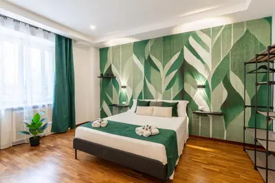 a bedroom with a bed with a green and white wall at Deluxe Apartment - Jacuzzi & Cinema, 500m to Metro B, 6-8 pax in Rome