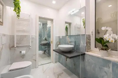 a bathroom with a sink and a toilet and a mirror at Deluxe Apartment - Jacuzzi & Cinema, 500m to Metro B, 6-8 pax in Rome