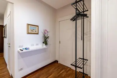 a room with a white wall and a white door at Deluxe Apartment - Jacuzzi & Cinema, 500m to Metro B, 6-8 pax in Rome