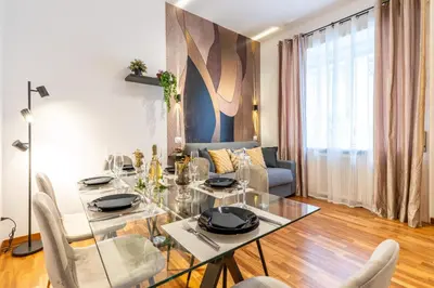 a dining room with a glass table and chairs at Deluxe Apartment - Jacuzzi & Cinema, 500m to Metro B, 6-8 pax in Rome