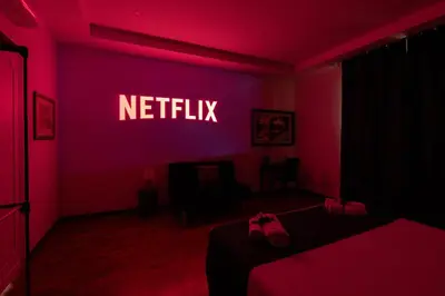 a bedroom with a netflix sign on the wall at Deluxe Apartment - Jacuzzi & Cinema, 500m to Metro B, 6-8 pax in Rome
