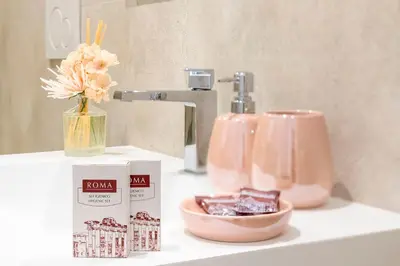 a bathroom counter with a box of chocolates and a vase of flowers at St Peter Museum in Rome