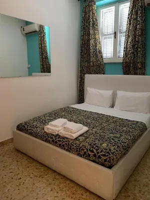 a bedroom with a bed with two towels on it at Three bedroom apartment with a view in Monti in Rome