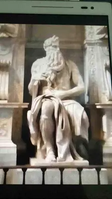 a statue of a man sitting on a table at Three bedroom apartment with a view in Monti in Rome
