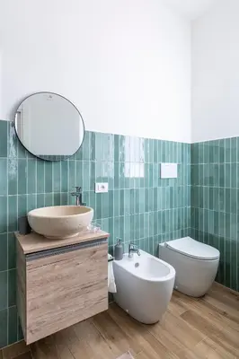 a bathroom with a sink and a toilet and a mirror at Vatican Cozy Studio in Rome