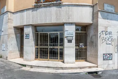 a building with a door with graffiti on it at Vatican Cozy Studio in Rome