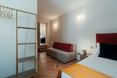 a bedroom with a bed and a couch in it at Casa mia Navona Rooms in Rome