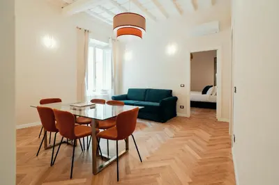 a living room with a table and chairs and a couch at Casa mia Navona Rooms in Rome