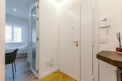 a room with a door leading to a bedroom at Chigi Home in Rome