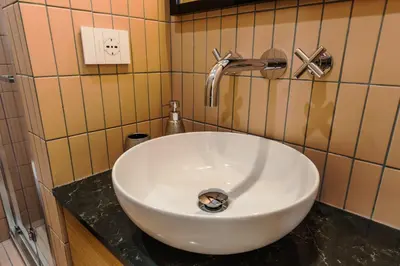 a white sink in a bathroom with a faucet at Chigi Home in Rome
