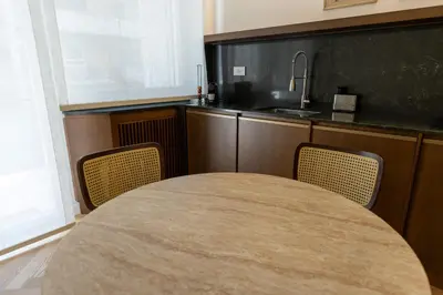 a kitchen with a table and two chairs and a sink at Chigi Home in Rome