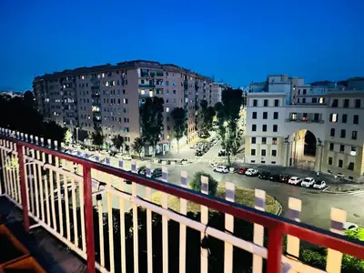 a table and chairs on the roof of a building at Sky Global Suites in Rome