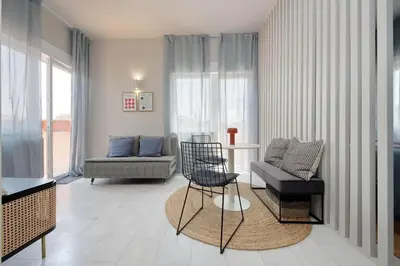 a living room with a couch and a table and chairs at Caracalla Charming Terrace Loft in Rome