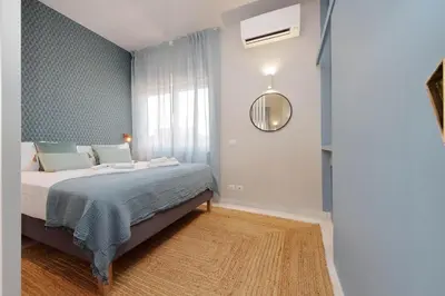 a bedroom with a large bed and a mirror at Caracalla Charming Terrace Loft in Rome