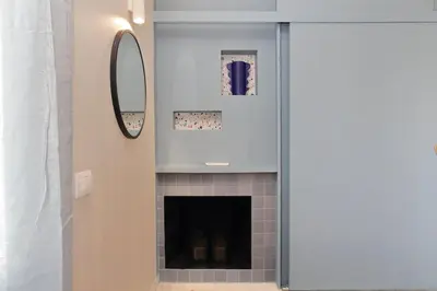 a bathroom with a fireplace and a mirror at Caracalla Charming Terrace Loft in Rome